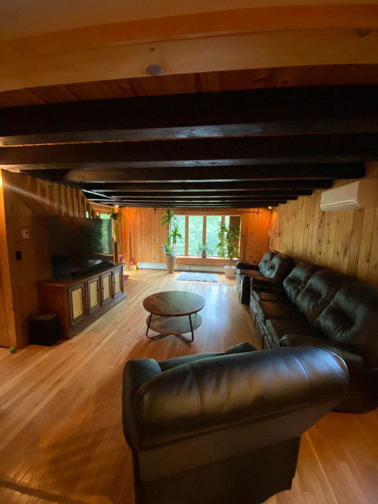 The living room with a cozy sofa, two couches and a TV for socializing, movie nights with friends & family or reading books.